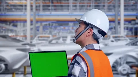 Engineer Working On A Green Screen Laptop In Car Factory Stock Footage 331579367