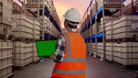 Engineer Working On A Green Screen Laptop at Fuel Warehouse Stock Footage 332153138
