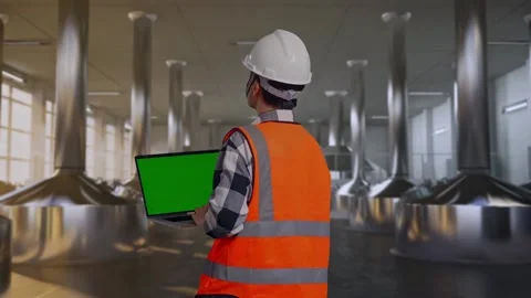 Engineer Working On A Green Screen Laptop at Beer Plant Stock Footage 332545000