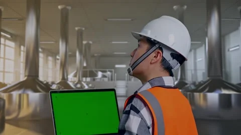 Engineer Working On A Green Screen Laptop at Beer Plant Stock Footage 332545761