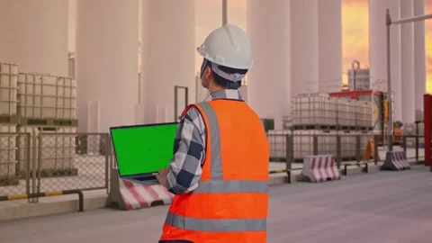 Engineer Working On A Green Screen Laptop at Storage Facility Stock Footage 335076491