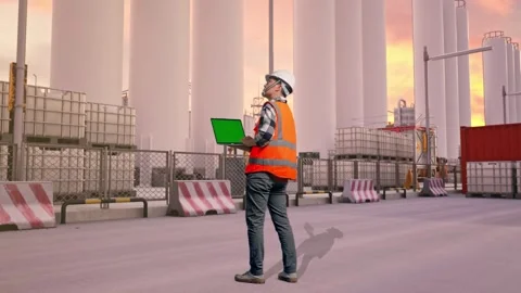 Engineer Working On A Green Screen Laptop at Storage Facility Stock Footage 335078001