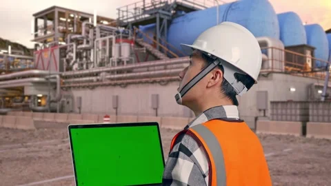 Engineer Working On A Green Screen Laptop at Gas Plant Stock Footage 337761686