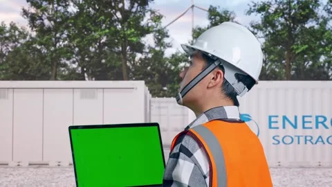 Engineer Working On A Green Screen Laptop with Energy Storage Stock Footage 337817910