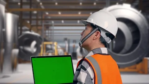Engineer Working On A Green Screen Laptop at Heavy Factory Stock Footage 340821010