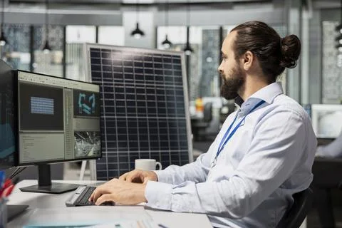 Engineer working for green tech company uses CAD program to optimize solar panel Photos