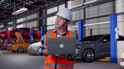 Engineer Working On A Laptop in Auto Repair Shop Stock Footage 313531379