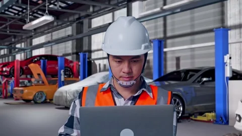 Engineer Working On A Laptop in Auto Repair Shop Stock Footage 313532463