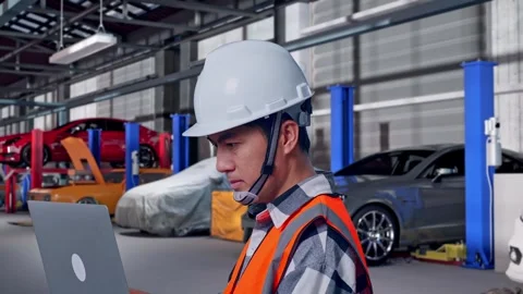 Engineer Working On A Laptop in Auto Repair Shop Stock Footage 313533211