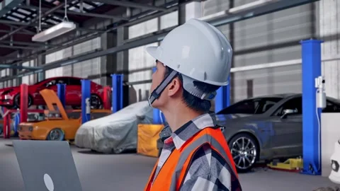 Engineer Working On A Laptop in Auto Repair Shop Stock Footage 313533248