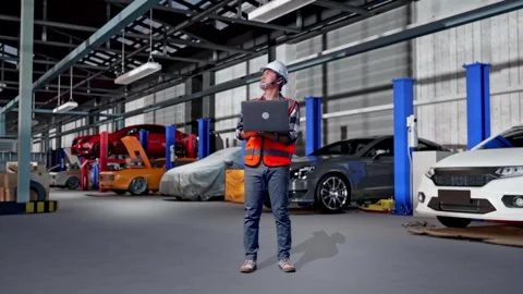 Engineer Working On A Laptop in Auto Repair Shop Stock Footage 313533841