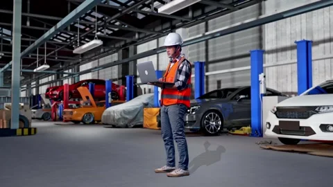 Engineer Working On A Laptop in Auto Repair Shop Stock Footage 313534015
