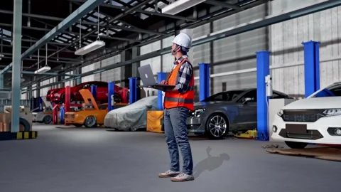 Engineer Working On A Laptop in Auto Repair Shop Stock Footage 313534029