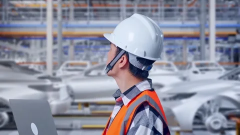 Engineer Working On A Laptop In Car Factory Stock Footage 331579197