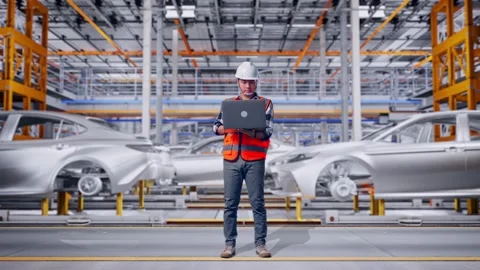 Engineer Working On A Laptop In Car Factory Stock Footage 331580088