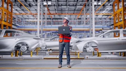Engineer Working On A Laptop In Car Factory Stock Footage 331580112