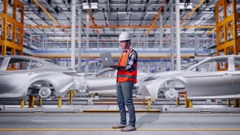 Engineer Working On A Laptop In Car Factory Stock Footage 331580525