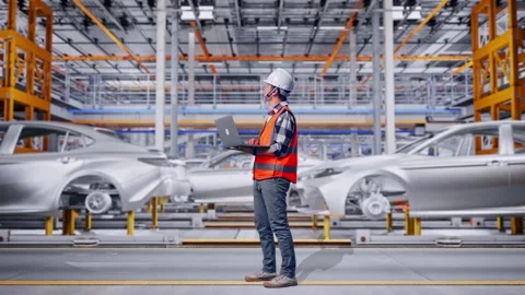 Engineer Working On A Laptop In Car Factory Stock Footage 331580580