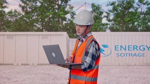 Engineer Working On A Laptop with Energy Storage Stock Footage 337816745