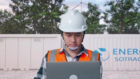 Engineer Working On A Laptop with Energy Storage Stock Footage 337817194