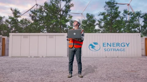 Engineer Working On A Laptop with Energy Storage Stock Footage 337818259
