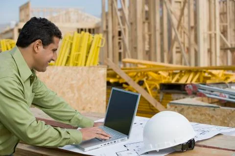 Engineer Working On Laptop At Site Stock Photos