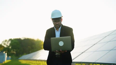Engineer working with laptop in solar panel farm Stock Footage 314408369