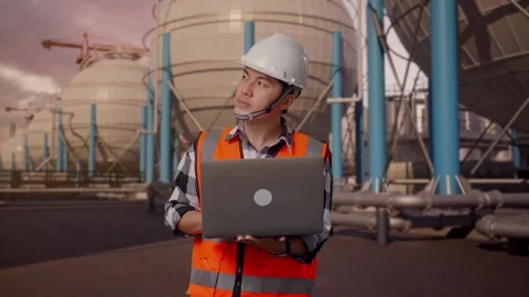 Engineer Working On A Laptop with Spherical Tank Stock Footage 335066667