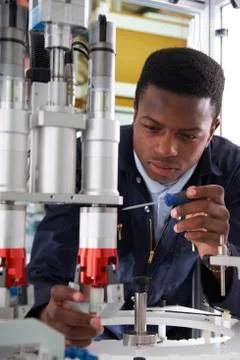 Engineer working on machine in factory Stock Photos