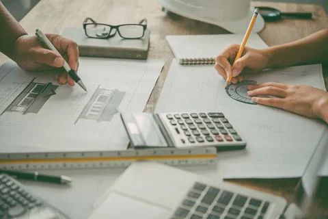 Engineer working in office with blueprints, inspection in workplace for archi Stock Photos