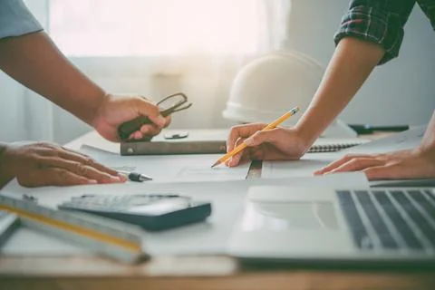 Engineer working in office with blueprints, inspection in workplace for archi Stock Photos