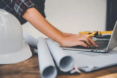 Engineer working in office with blueprints, inspection in workplace for archi Stock Photos