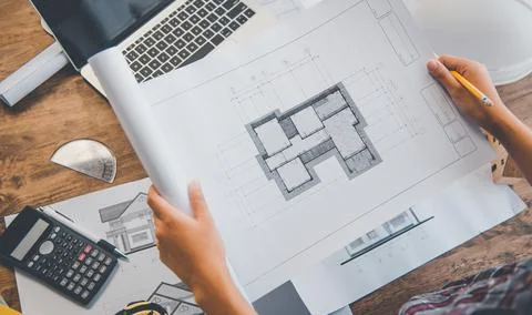 Engineer working in office with blueprints, inspection in workplace for archi Stock Photos