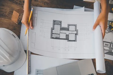 Engineer working in office with blueprints, inspection in workplace for archi Stock Photos