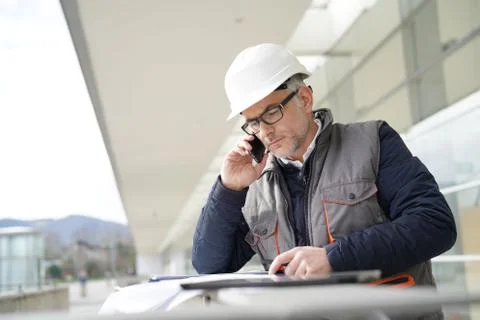 Engineer working on outdoor project and talking on phone Stock Photos