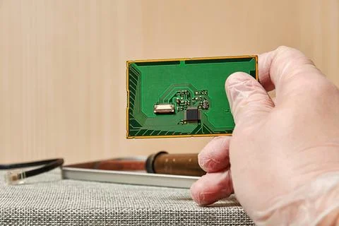 Engineer working on a PCB with a chip in the laboratory Stock Photos