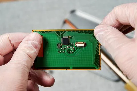 An engineer working on repairing a microchip in a tech laboratory Foto stock