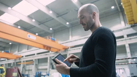 Engineer working with smart app on tablet in production site Stock Footage 132703160