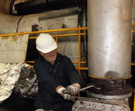 An engineer working on a steam valve Stock Photos
