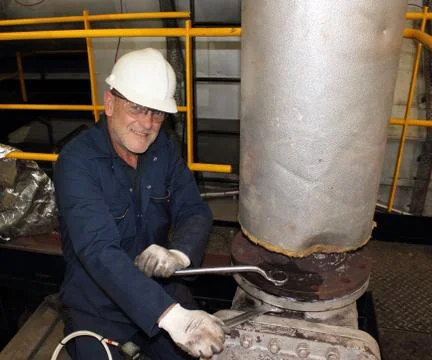 An engineer working on a steam valve Stock Photos