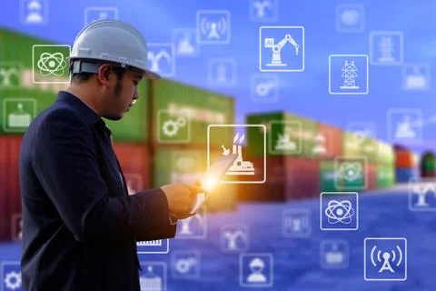 The engineer is working with tabet on containers background. 写真素材