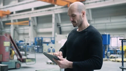 Engineer working with tablet in a factory Stock Footage 132704364