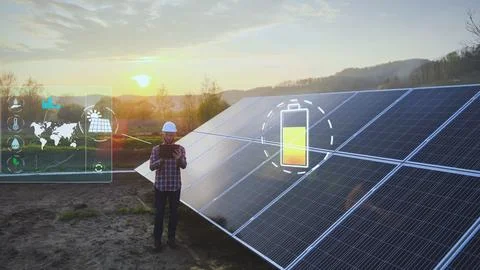 Engineer working on a tablet, inspecting solar cell data levels Foto stock