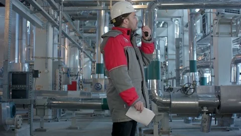 Engineer working in a thermal power plant, talking on the walkie-talkie Stock Footage 71504533