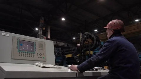 The engineer works with the automated operating console at metallurgical plant. Video stock 84110558
