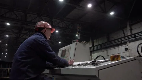 The engineer works with the automated operating console at metallurgical plant. Video stock 84111137