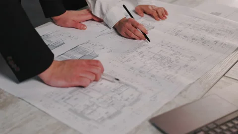 Engineer works in a bright office with a large window, concentrates and draws Stock Footage 234195413