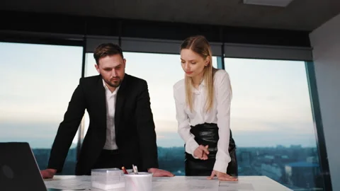 Engineer works in a bright office with a large window, concentrates and draws Stock Footage 245728879