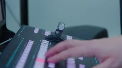 An engineer works with a control panel with a green and red buttons Stock Footage 277577395