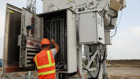 An engineer works with at an electric transformer Stock-Footage 194729012